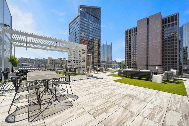 view of patio / terrace featuring a pergola, outdoor lounge area, and a city view