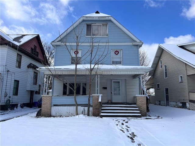 american foursquare style home with a porch