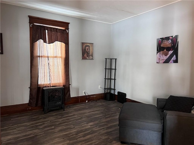 sitting room with dark wood finished floors and baseboards