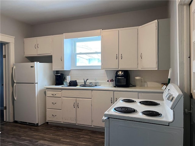 kitchen with white appliances, white cabinetry, light countertops, dark wood-style floors, and tasteful backsplash