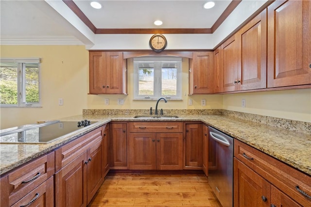 kitchen featuring light stone counters, a sink, stainless steel dishwasher, and black electric cooktop