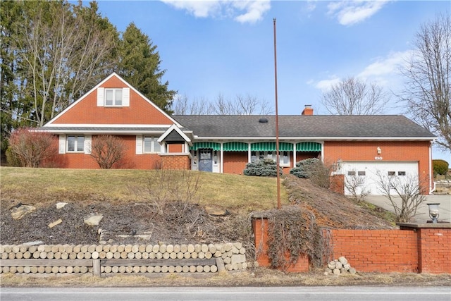 view of front of house featuring brick siding, a chimney, concrete driveway, a garage, and a front lawn