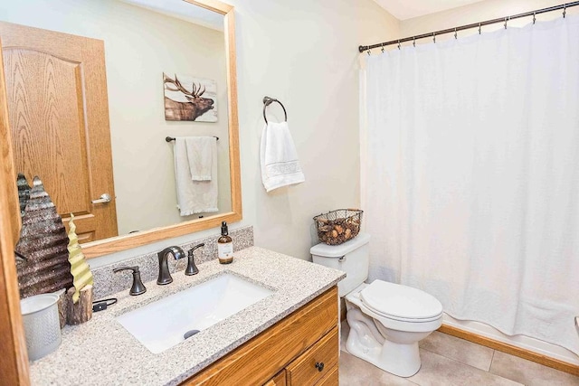 bathroom with toilet, tile patterned floors, and vanity