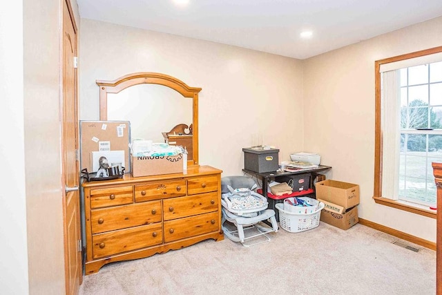 interior space with light carpet, baseboards, and visible vents