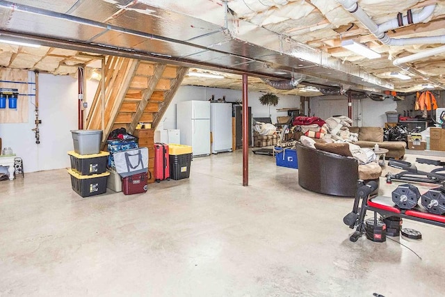 unfinished basement with freestanding refrigerator and refrigerator