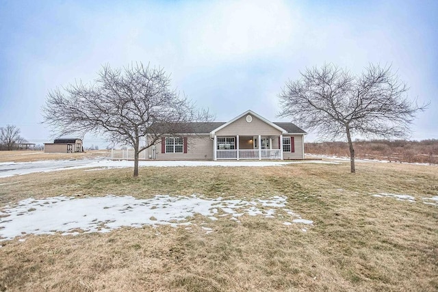 view of front of home featuring covered porch and a front yard