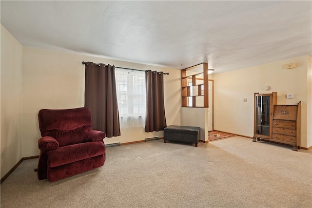 sitting room with baseboards, visible vents, and carpet flooring