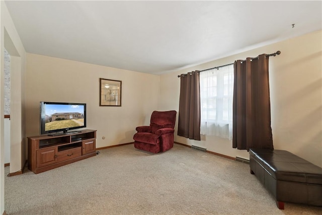 sitting room with light carpet, visible vents, and baseboards