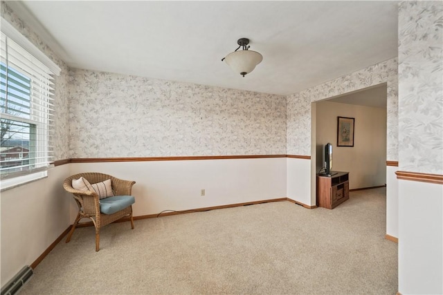 unfurnished room with baseboards, light colored carpet, visible vents, and wallpapered walls