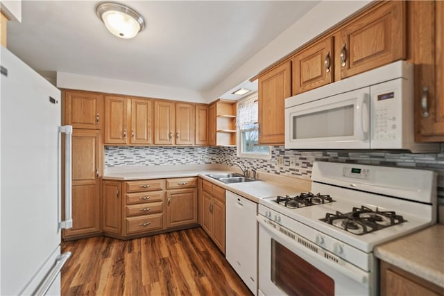 kitchen with white appliances, tasteful backsplash, brown cabinetry, dark wood-style flooring, and light countertops