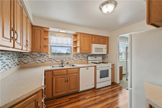 kitchen featuring dark wood finished floors, open shelves, light countertops, a sink, and white appliances