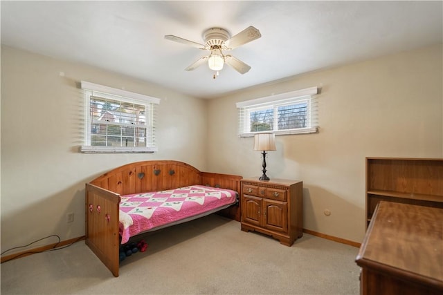 bedroom featuring light carpet, ceiling fan, and baseboards