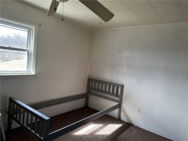 staircase with ornamental molding, ceiling fan, and carpet floors