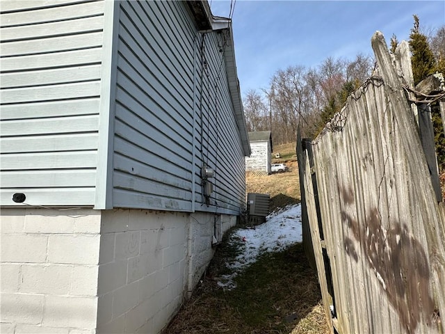 view of home's exterior with central AC and fence