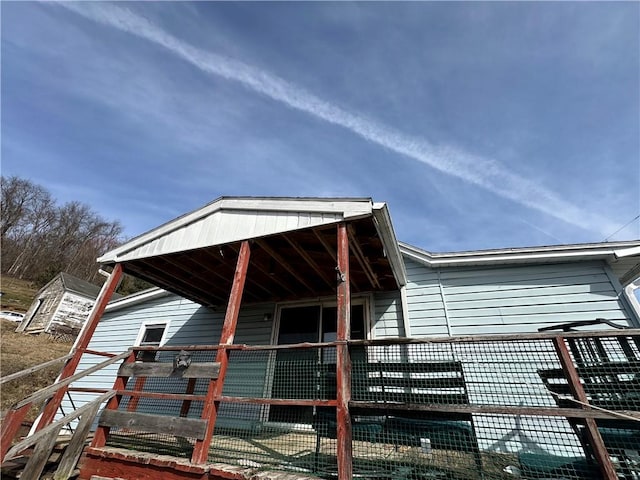 view of home's exterior with an outbuilding and an exterior structure