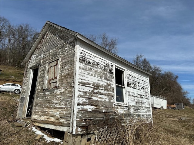 view of property exterior with an outbuilding