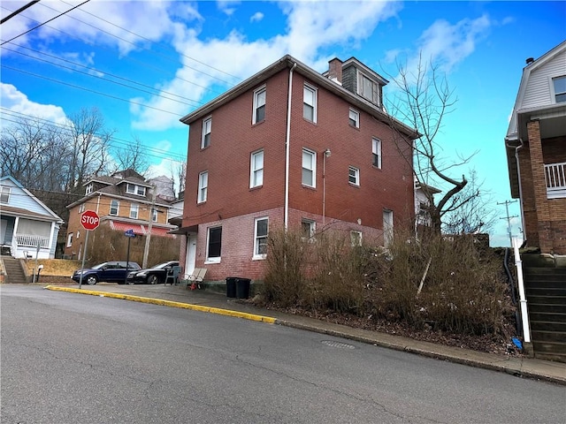 view of property exterior featuring a residential view and stairway