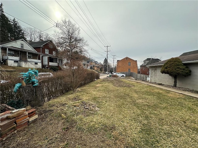 view of yard with fence and a residential view