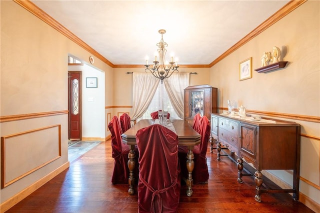 dining area featuring a chandelier, wood-type flooring, baseboards, and crown molding