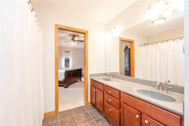 ensuite bathroom with double vanity, ensuite bath, tile patterned flooring, and a sink