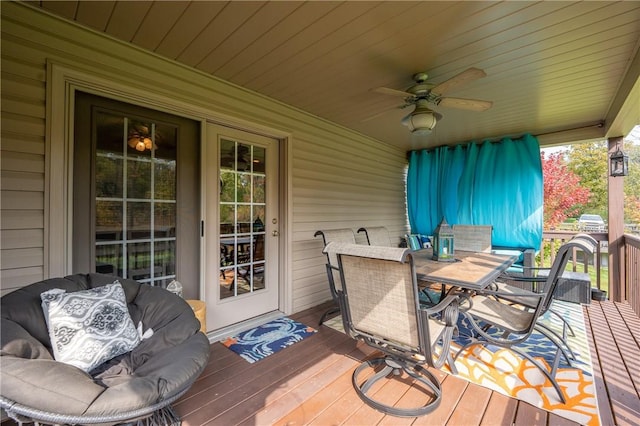 wooden deck with ceiling fan and outdoor dining area