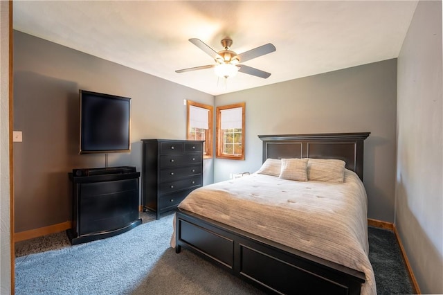 carpeted bedroom with ceiling fan and baseboards