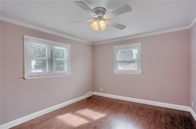 empty room featuring visible vents, baseboards, a ceiling fan, ornamental molding, and wood finished floors