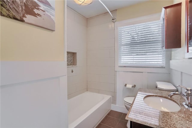 full bathroom featuring toilet, tile patterned floors, bathing tub / shower combination, and vanity