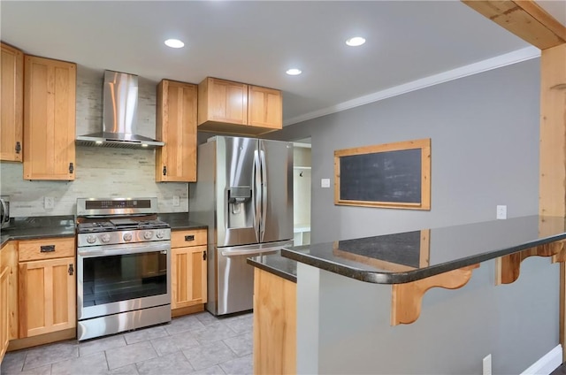 kitchen featuring stainless steel appliances, wall chimney range hood, a kitchen breakfast bar, and a peninsula