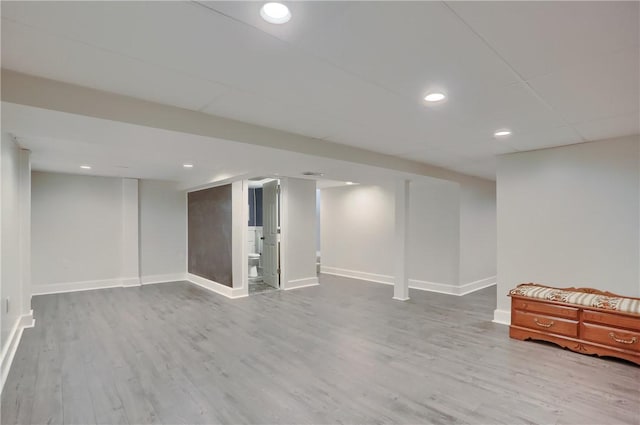 finished basement featuring recessed lighting, wood finished floors, and baseboards