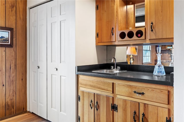 kitchen with dark countertops, brown cabinetry, and a sink