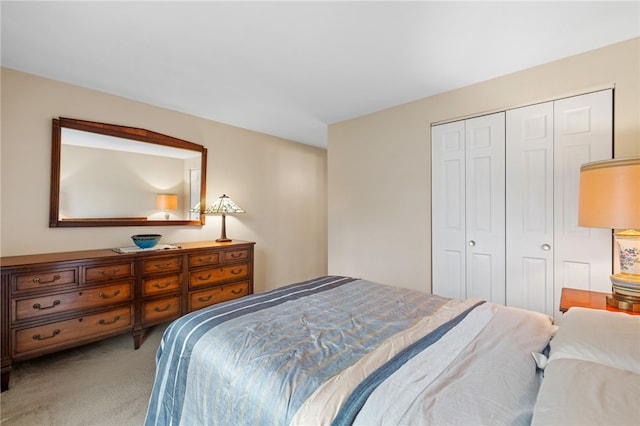 bedroom featuring light carpet and a closet