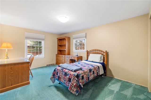 carpeted bedroom with visible vents and multiple windows