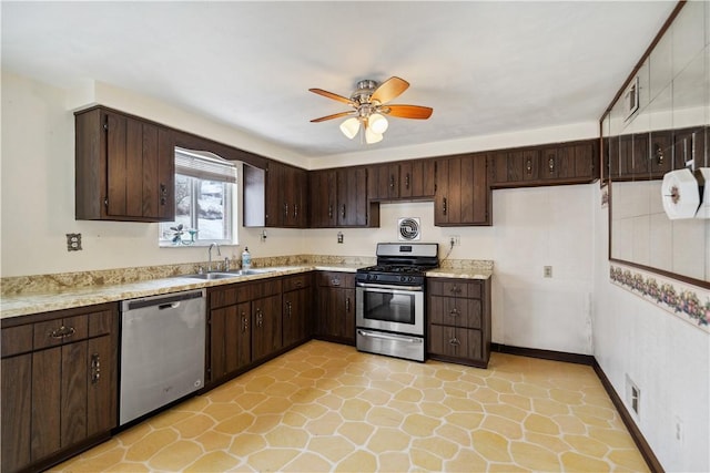 kitchen featuring a sink, stainless steel appliances, dark brown cabinets, and light countertops