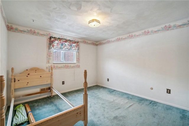 unfurnished bedroom with carpet floors, visible vents, and baseboards