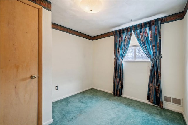 carpeted empty room with visible vents and baseboards