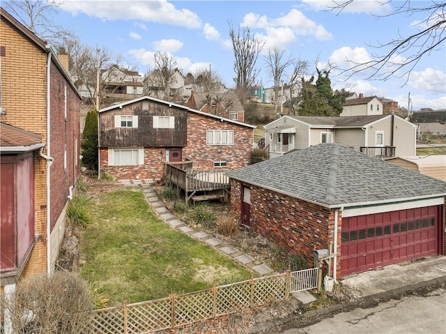 view of side of property featuring brick siding, a residential view, fence, and a yard