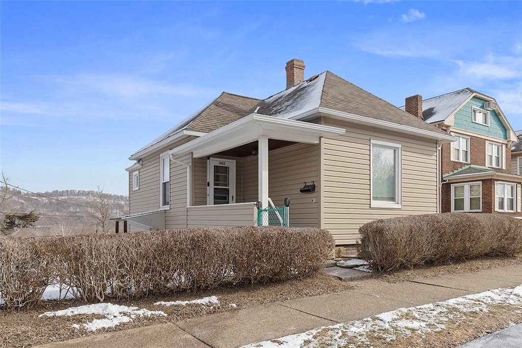 1805 Ridge Ave, Coraopolis, PA 15108 - view of front of home featuring roof with shingles, a porch, and a chimney