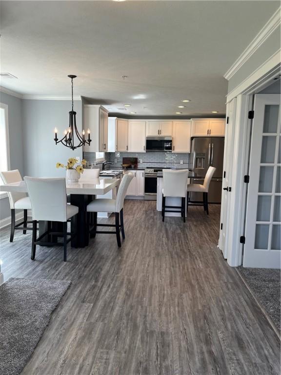 115 White Fox Ct Unit 33, North Sewickley Twp, PA 16117 - dining space featuring crown molding, dark wood-style floors, a chandelier, and recessed lighting