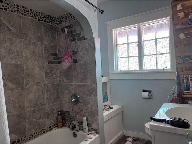 full bathroom featuring baseboards, vanity, toilet, and shower / bathtub combination