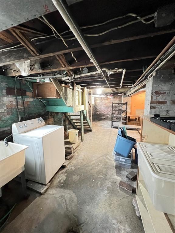 unfinished basement featuring washer / dryer