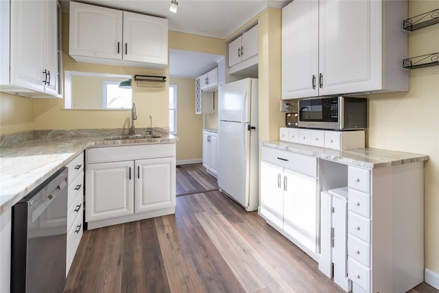 kitchen with light stone counters, stainless steel appliances, dark wood-type flooring, a sink, and white cabinetry