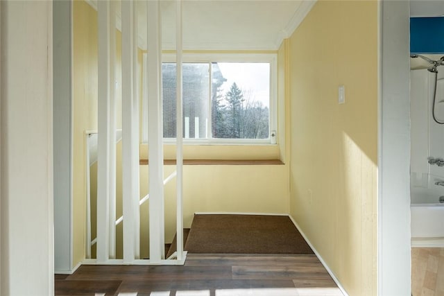 hall with wood finished floors and baseboards