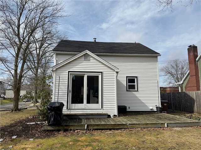 back of house featuring fence and a wooden deck