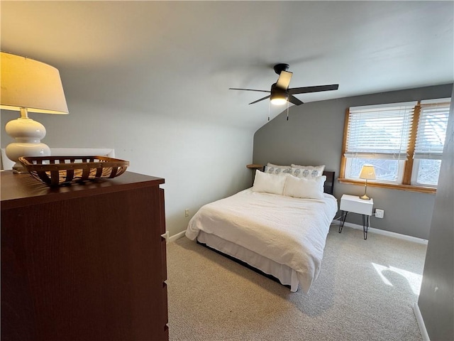 carpeted bedroom with baseboards and vaulted ceiling