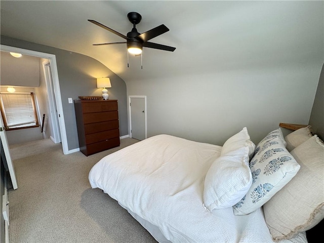 carpeted bedroom featuring a ceiling fan, lofted ceiling, and baseboards