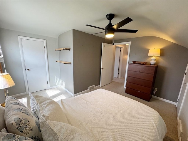 bedroom with light carpet, a ceiling fan, visible vents, and baseboards