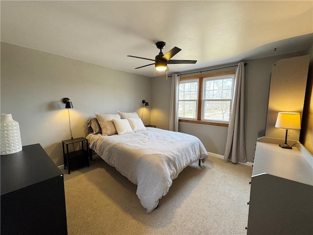 bedroom featuring baseboards, a ceiling fan, and light colored carpet