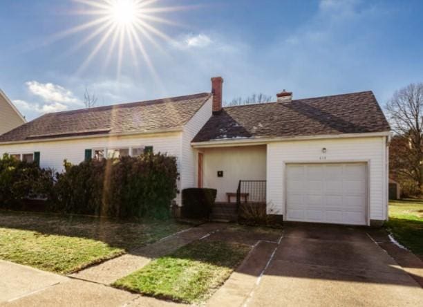 ranch-style house with driveway and an attached garage