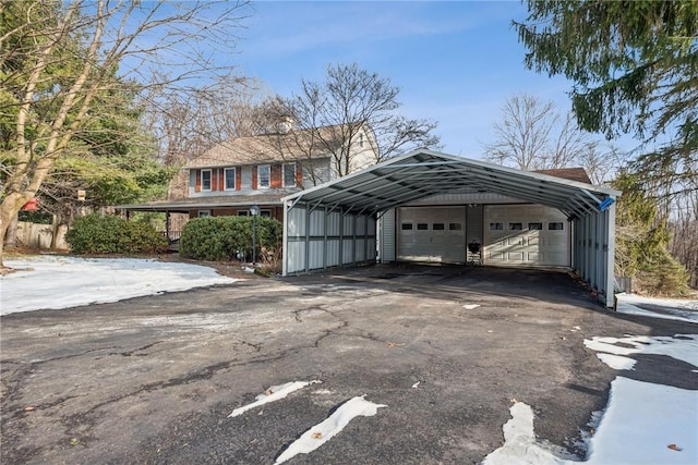 view of car parking featuring a carport and a detached garage